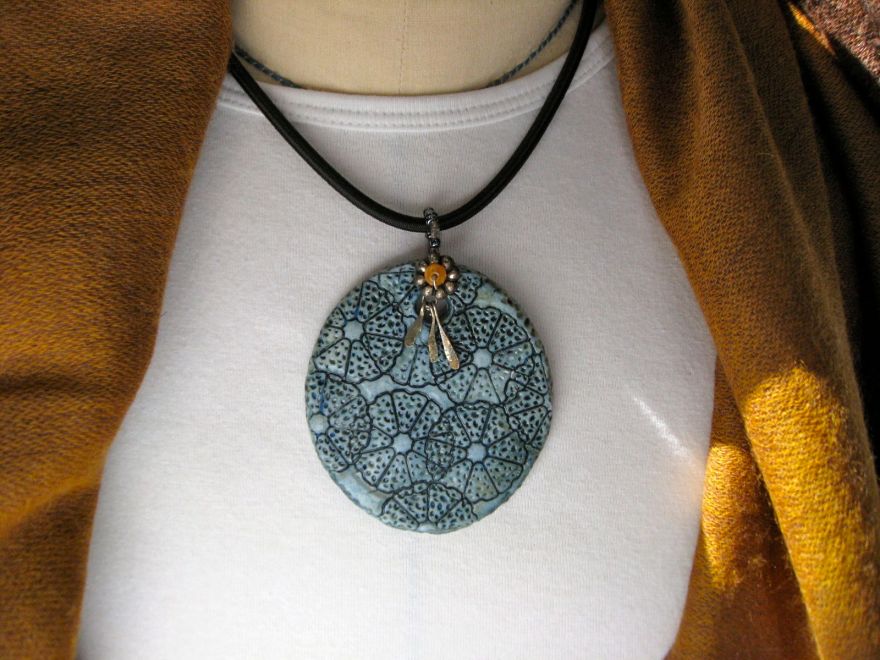 "Citrus Demin" Hand stamped ceramic pendant, oxide rub, celadon and clear glazes; found beads and custom made black cord with stainless steel clasp